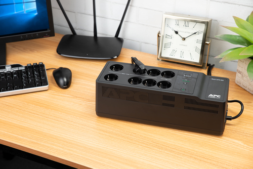 APC Back-UPS on office desk highlighting compact size and black finish