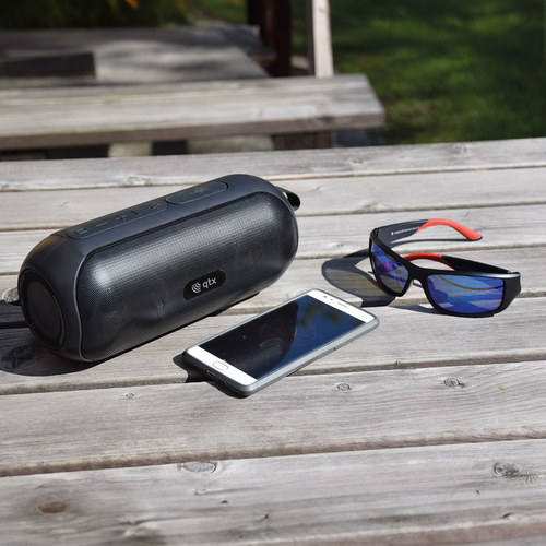 Qtx 100.619UK compact speaker on outdoor picnic table