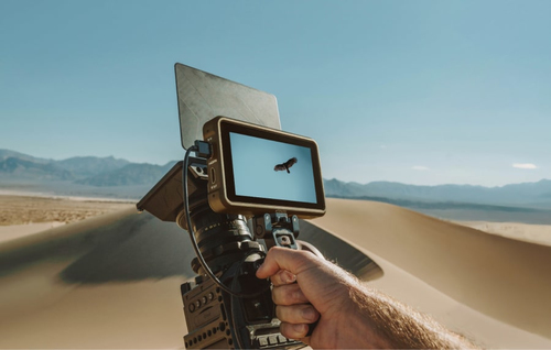 Filmmaker using Atomos Ninja monitor outdoors in bright sunlight